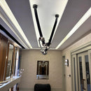 Modern interior design with decorative ceiling lights and wall art.