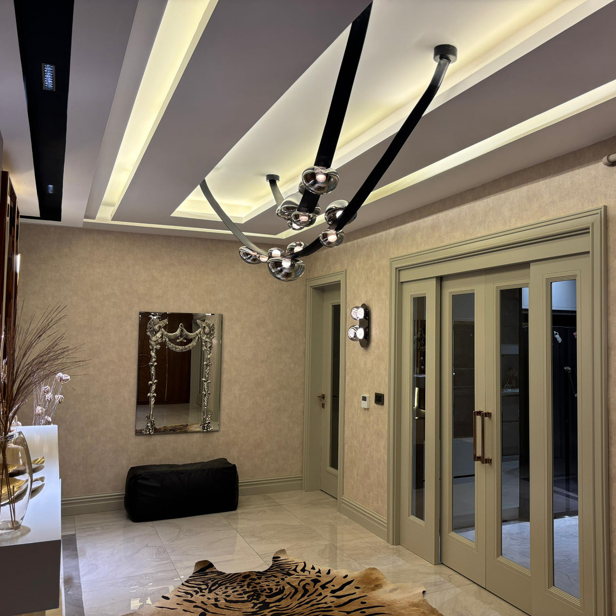 Modern interior design of a hallway with decorative lighting and wall mirror.
