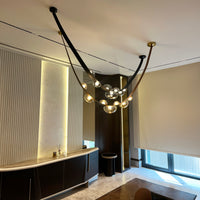 Modern chandelier hanging in a stylish room with neutral decor