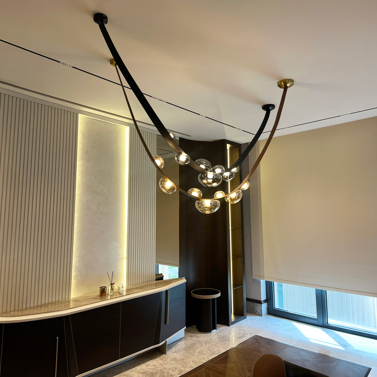Modern chandelier hanging in a stylish room with neutral decor