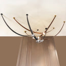 Modern chandelier with curved metal arms and glass shades on a ceiling.