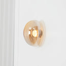 Gold wall sconce on a white wall