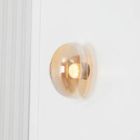 Gold wall sconce on a white wall
